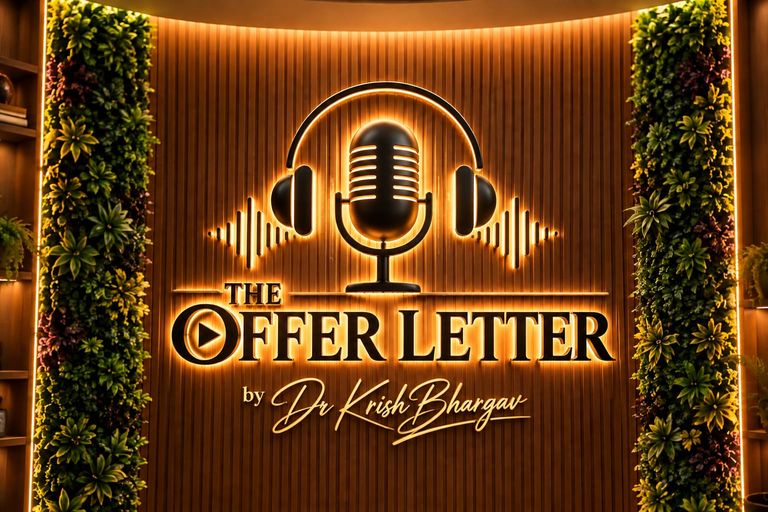 The backlit The Offer Letter logo wall in the studio, set in fluted wood between two green plant walls